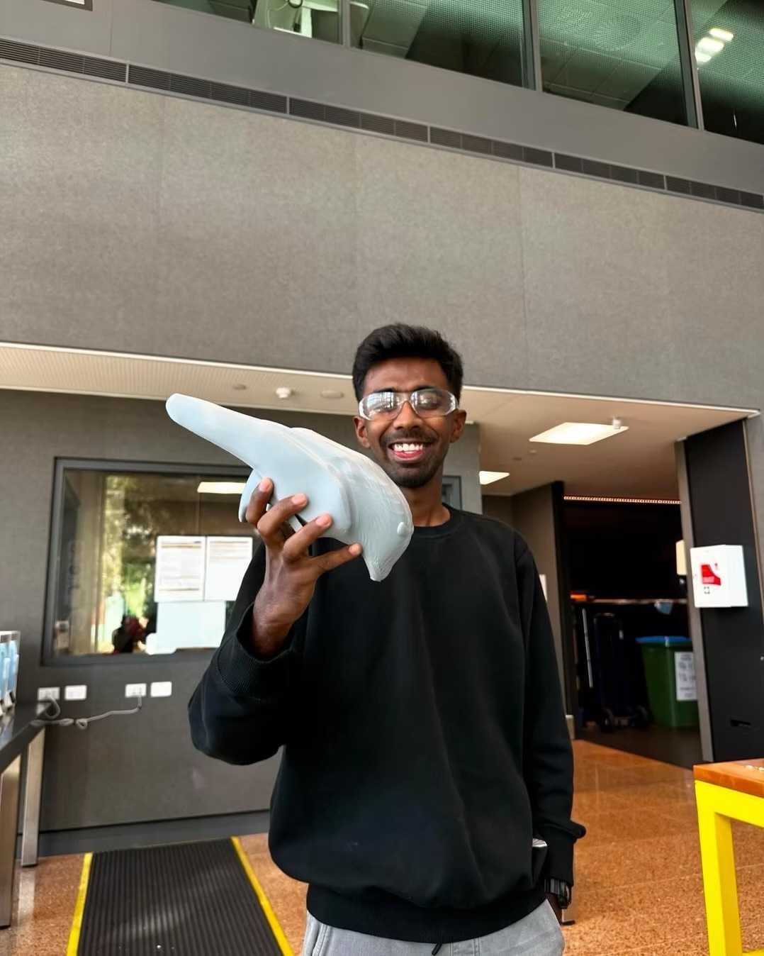 The founder at the lab, holding a fresh PROTO-X print